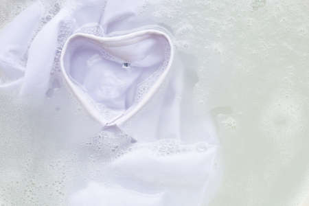Soak a cloth before washing, white shirtの写真素材