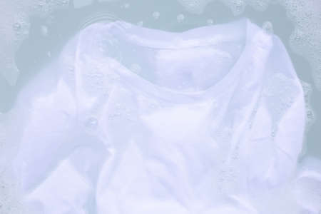 Soak a cloth before washing, white T-shirt