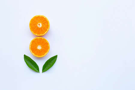 Fresh orange citrus fruit with green leaves on white background. Copy space