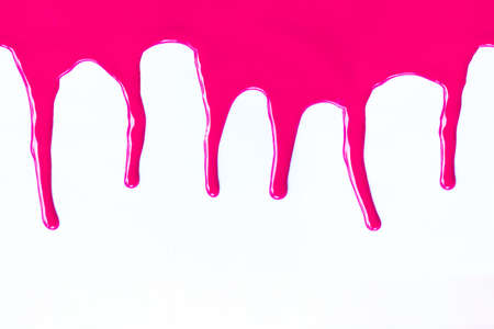 Pink paint dripping on a white backgroundの写真素材