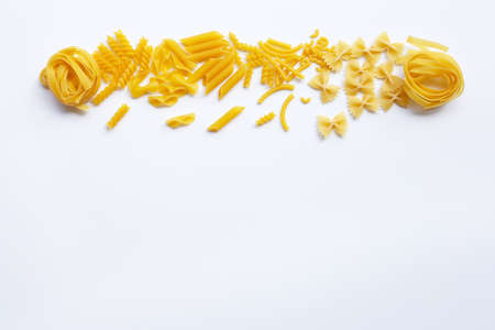 Different types of dry pasta on white backgroundの写真素材