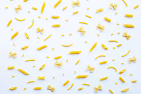 Different types of dry pasta on white backgroundの写真素材