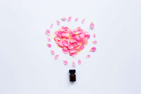 Bottle of rose essential oil for aromatherapy on white background.の写真素材