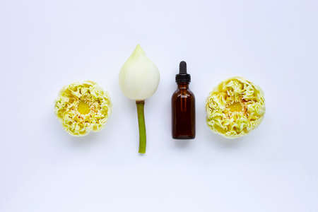 Lotus essential oil with lotus flowers on white background. Top viewの写真素材