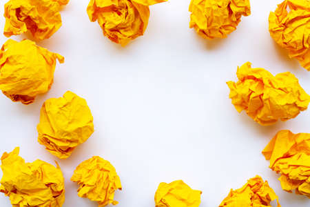 Yellow crumpled paper ball isolated on white backgroundの写真素材