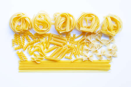 Different types of dry pasta on white backgroundの写真素材