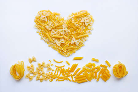 Different types of dry pasta on white backgroundの写真素材