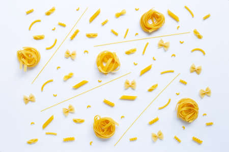 Different types of dry pasta on white backgroundの写真素材