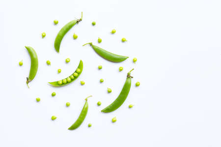 Fresh green pea pods and peas on white background. Copy spaceの写真素材
