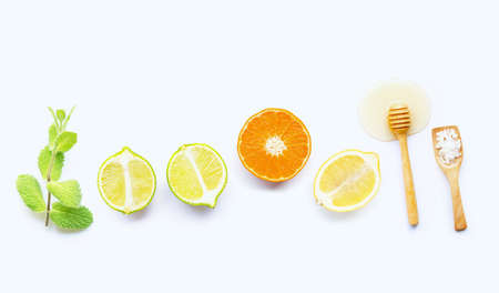 Mint, salt and honey with citrus tropical fruit isolated on whiteの写真素材