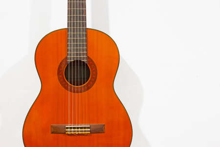 Classic acoustic guitar on white wallの写真素材