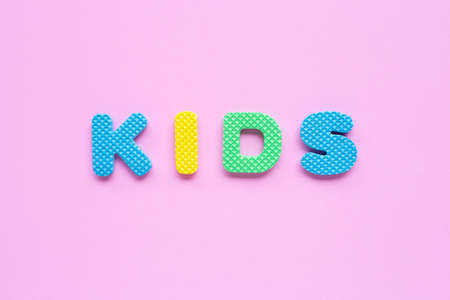 Alphabet "KIDS" on pink background. Top viewの写真素材
