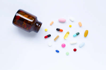 Colorful tablets with capsules and pills on white background.の写真素材
