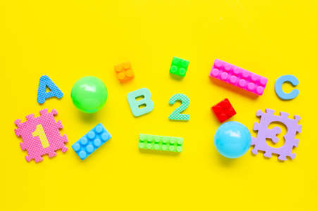 Colorful Kids toys on yellow background. Top viewの写真素材