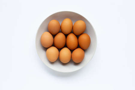 Eggs on white dish, white background. Top viewの写真素材