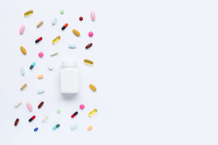 Colorful tablets with capsules and pills on white background.の写真素材