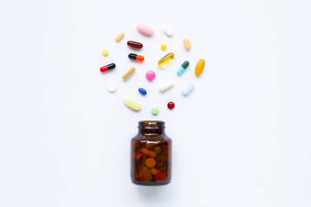 Colorful tablets with capsules and pills on white background.の写真素材
