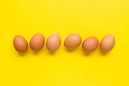 Eggs on yellow background. Top view