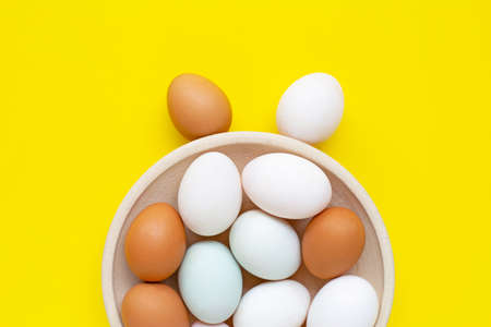 Eggs on yellow background.  Happy easter bunny. Top viewの写真素材