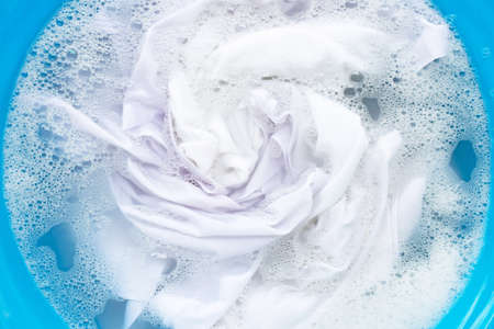 White clothes soak in powder detergent water dissolution. Laundry conceptの写真素材