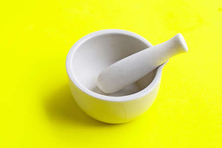 Mortar and pestle on green background. Copy spaceの写真素材