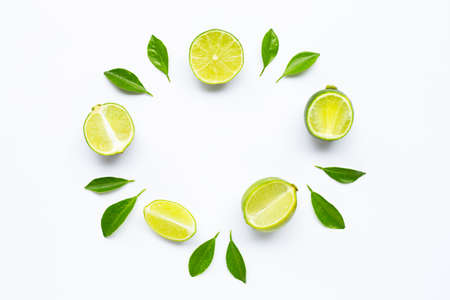 Limes with leaves isolated on white background.