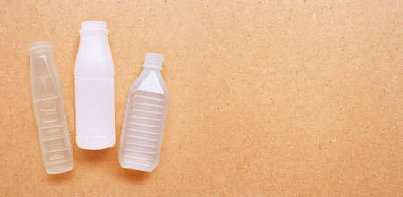Plastic bottles on plywood background. Copy spaceの写真素材