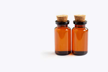 Brown bottle with essential oils on white background