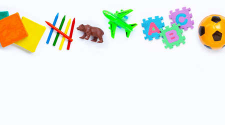 Colorful kids toys on white background. Copy space