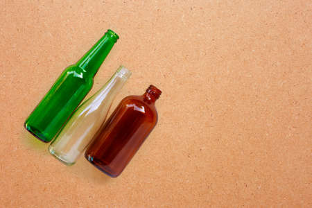 Glass bottles on plywood background. Copy space
