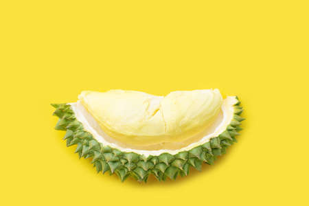 Ripe cut durian on yellow background. Top view