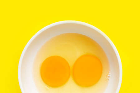 Eggs on yellow background. Top viewの写真素材