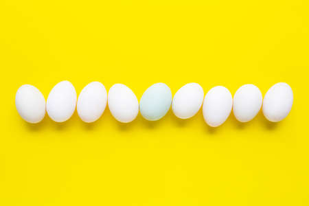 White eggs on yellow background.  Top view