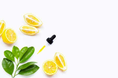 Lemon essential oil and lemon fruits on white background. Copy spaceの写真素材