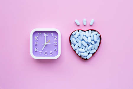 Clock with "PrEP" ( Pre-Exposure Prophylaxis). used to prevent HIV on pink background. Top viewの写真素材