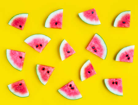 Slices of watermelon on yellow background. Top view