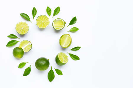 Limes with leaves isolated on white background.の写真素材