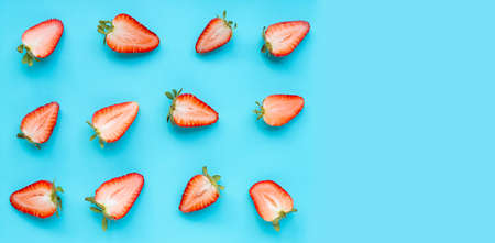 Ripe strawberries on blue background. Copy space