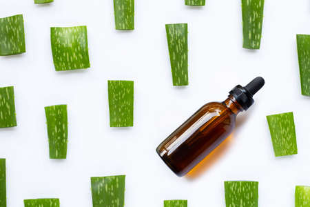 Essential oil with Aloe Vera cut pieces on white background.の写真素材