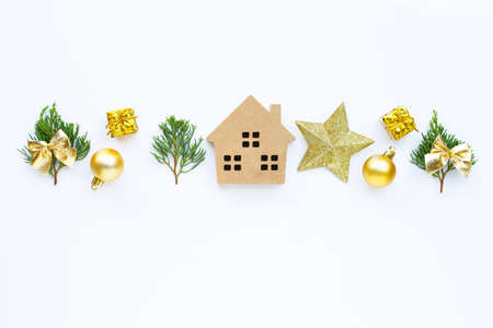 Merry Christmas and Happy Holidays, Miniature house with Christmas composition. gifts, pine branches and decorations on white background. Copy spaceの写真素材