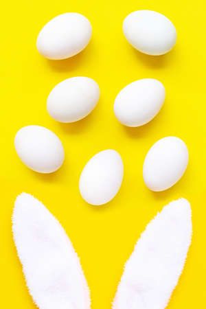 cute bunny ears with eggs on yellow background. Easter conceptの写真素材