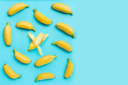 Banana on blue background. Top view with copy spaceの写真素材