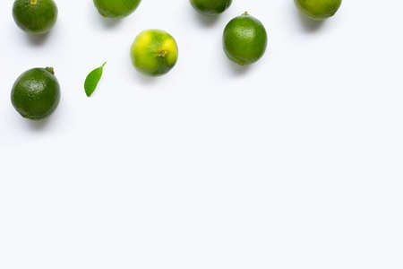 Limes on white background. Copy space