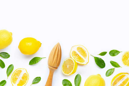 Fresh lemon and leaves with wooden juicer on white background.の写真素材