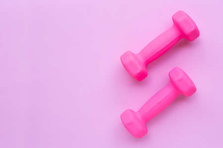 Top view of pink dumbbells isolated on pink background. Copy spaceの写真素材