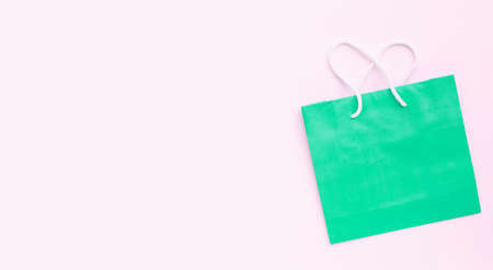 Paper shopping bag on pink background.の写真素材