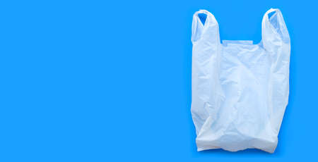 White plastic bag on blue background. Copy spaceの写真素材