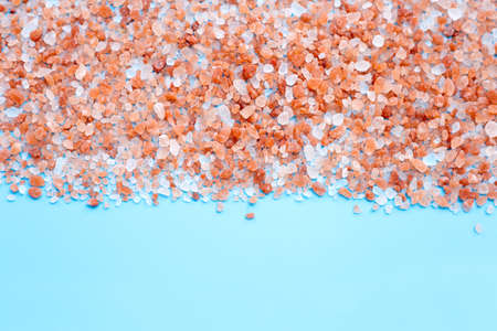 Pink himalayan salt on blue background. Copy spaceの写真素材
