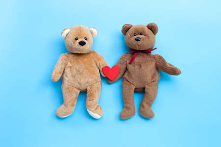 Bear toy couple with heart on blue background. Copy spaceの写真素材