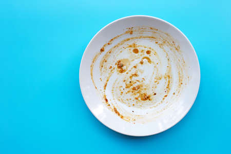 Dirty dish on blue background. Top view, Copy spaceの写真素材
